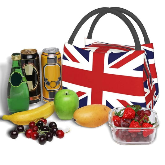 Lunchbag with a zip over the top and black handles.  The lunch bag is the Union Jack flag.  Surrounded by fresh fruit and vegetables that you might like to take for your lunch